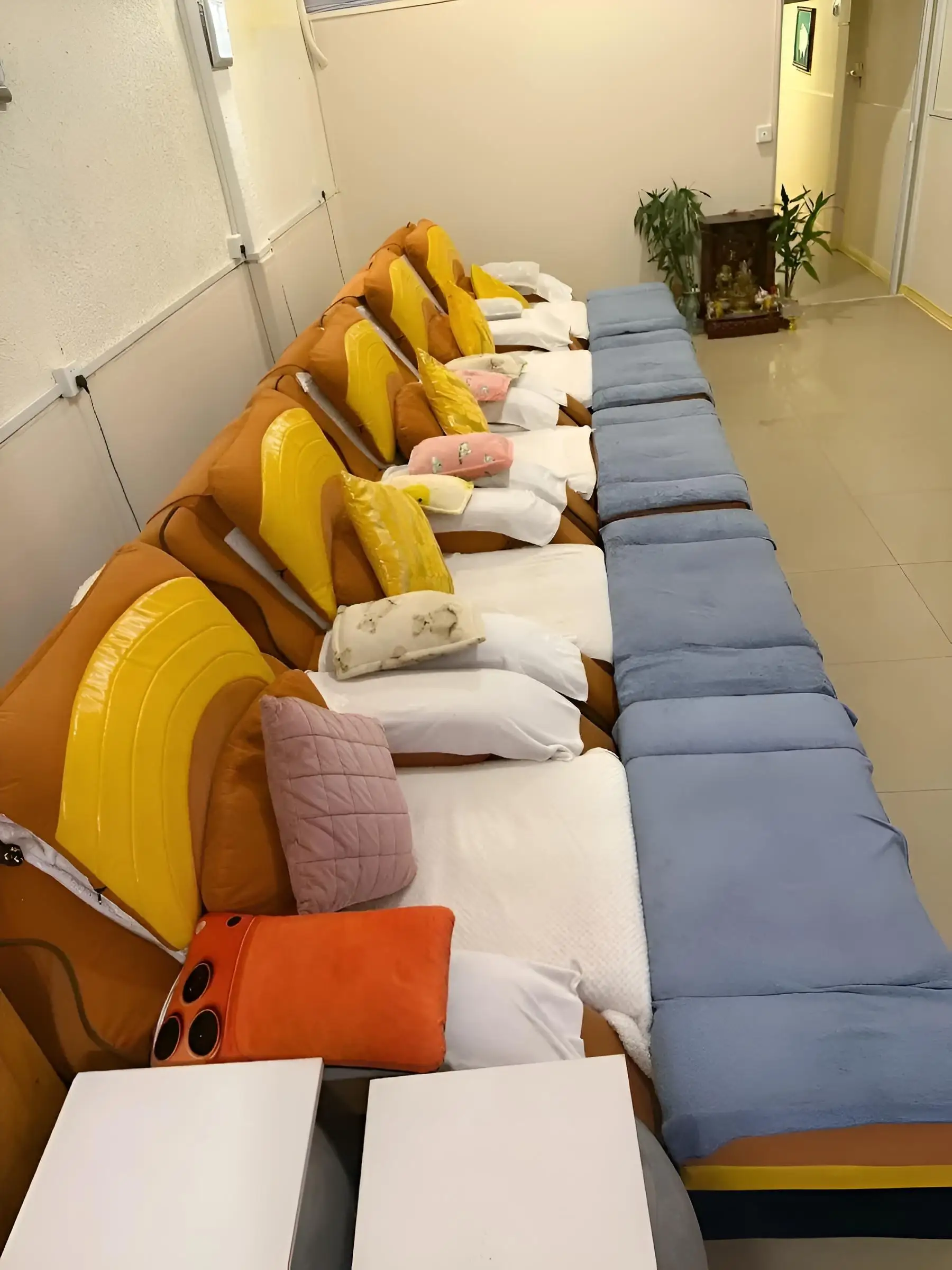 Close view of the padded reclining massage chairs with cushions and folded blankets
